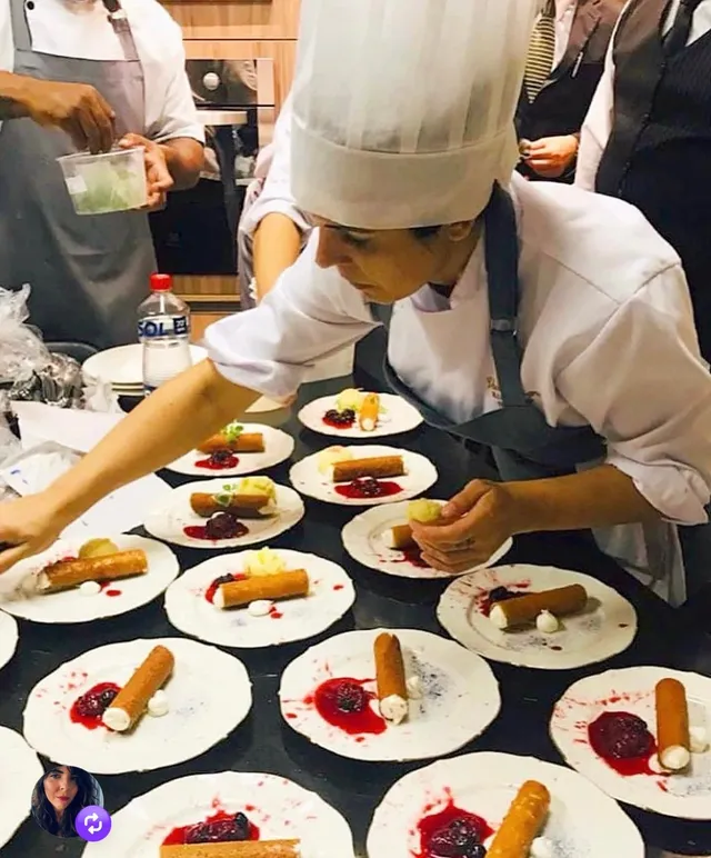 A wide line of plated dishes ready to leave the kitchen for service