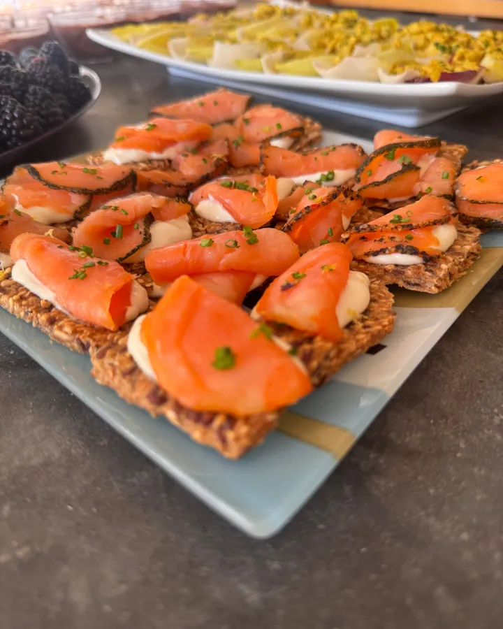 Smoked-salmon canapes on seeded crisps, plated for passing