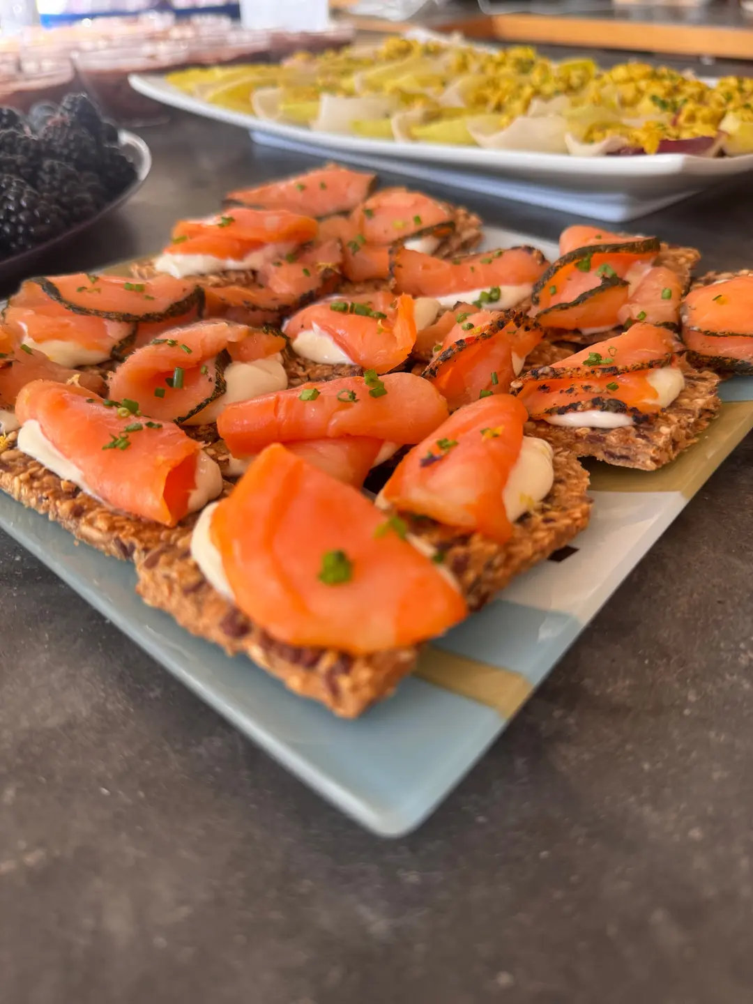 Smoked-salmon canapes on seeded crisps, plated for passing